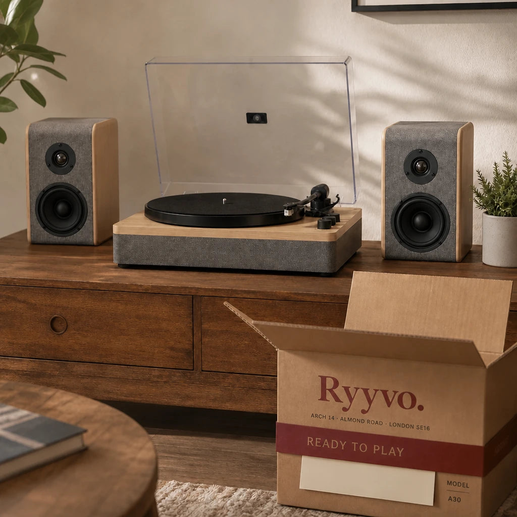 Ryyvo A30 record player with its two speakers on a sideboard, next to the opened Ryyvo carton